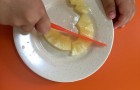 Children cutting their own pineapple to make lassi